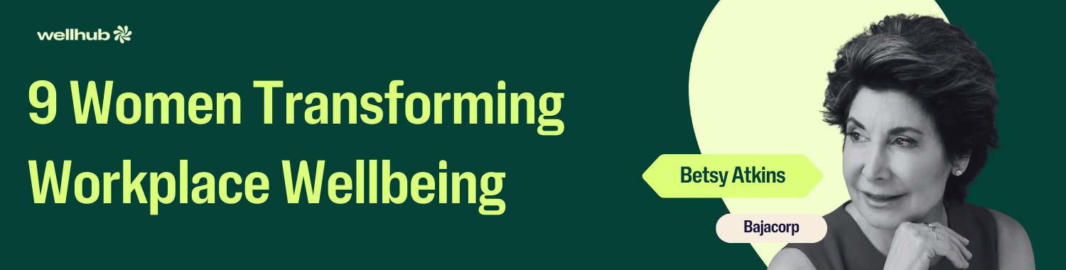 Banner reading “9 Women Transforming Workplace Wellbeing” with a black-and-white portrait of Betsy Atkins of Bajacorp on a dark green background with Wellhub branding.