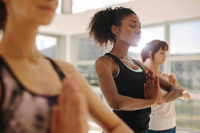 Woman dressed in workout clothes doing yoga. 