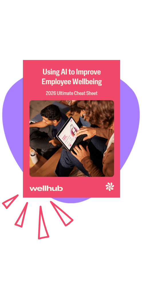 Promotional graphic of a Wellhub ebook titled “Using AI to Improve Employee Wellbeing: 2026 Ultimate Cheat Sheet,” showing coworkers reviewing information on a tablet against a purple accent shape.