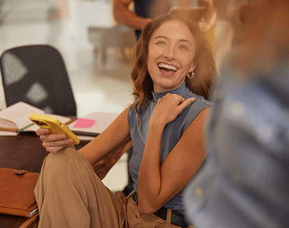 Woman smiling with a cellphone in her hand