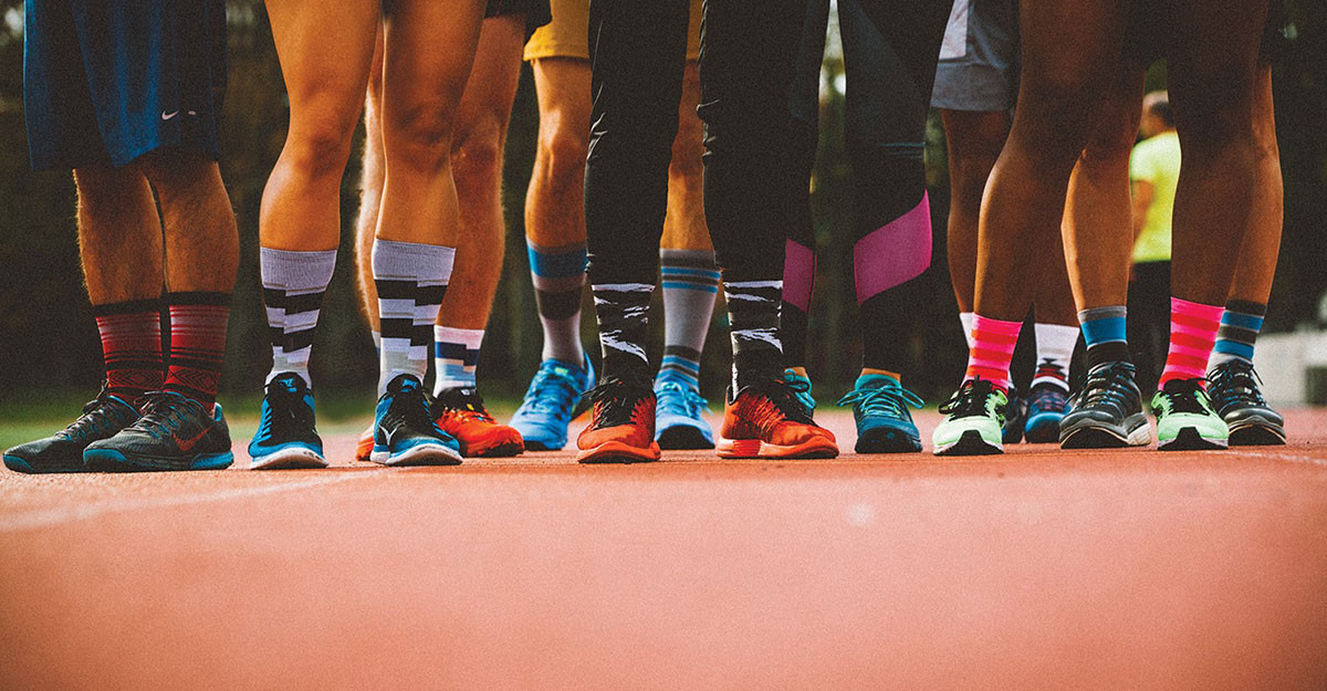 Runners wearing socks and running shoes on a track