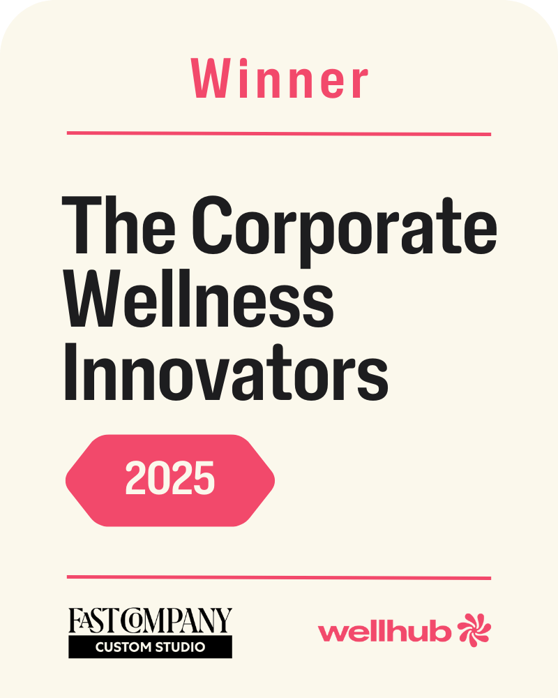 Award badge graphic. Header reads “Winner.” Main text: “The Corporate Wellness Innovators 2025.” Logos for Fast Company Custom Studio and Wellhub appear at the bottom.