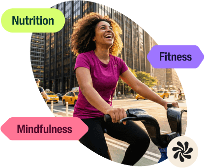 A woman laughing while biking in New York City, with labels for "Nutrition," "Fitness," and "Mindfulness" floating around her.